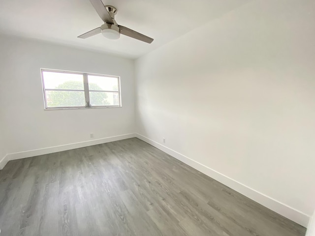 empty room with hardwood / wood-style flooring and ceiling fan