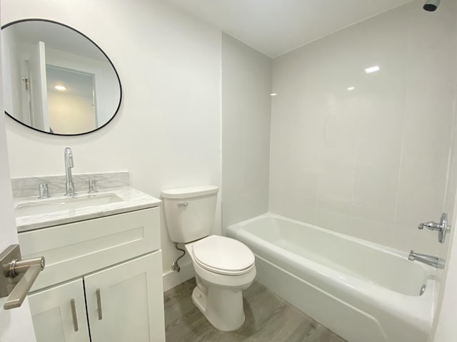 full bathroom with  shower combination, toilet, wood-type flooring, and vanity