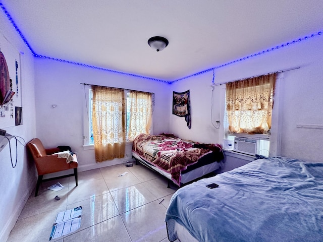 bedroom featuring light tile patterned floors and cooling unit