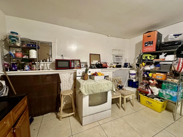 interior space with light tile patterned floors and an AC wall unit