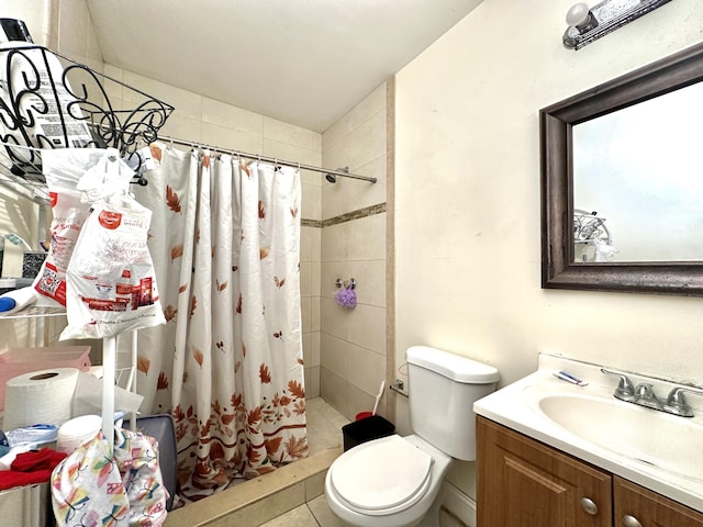 bathroom with vanity, curtained shower, tile patterned floors, and toilet