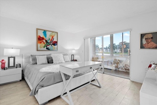 bedroom with access to exterior, baseboards, and light wood finished floors