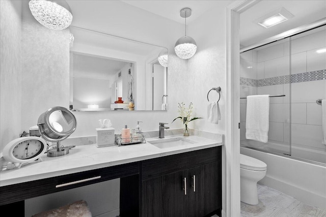 bathroom featuring enclosed tub / shower combo, toilet, and vanity