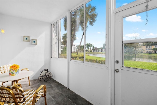 sunroom / solarium with a water view