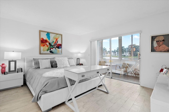 bedroom with light wood finished floors and access to exterior