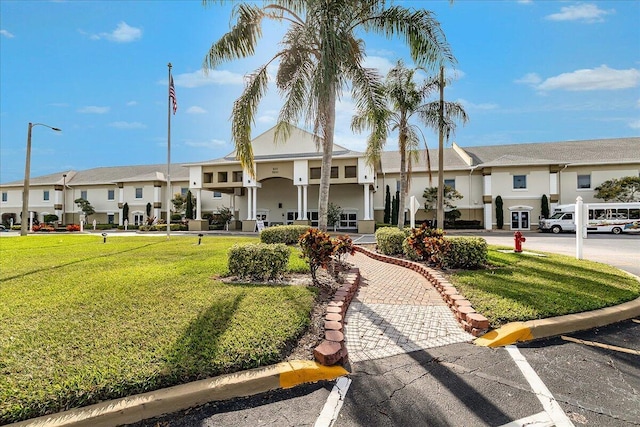 view of property with a residential view and uncovered parking