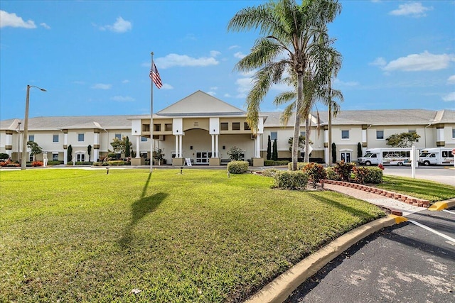 view of building exterior with a residential view and uncovered parking