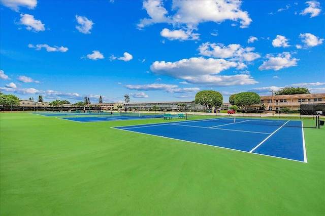 view of tennis court featuring fence