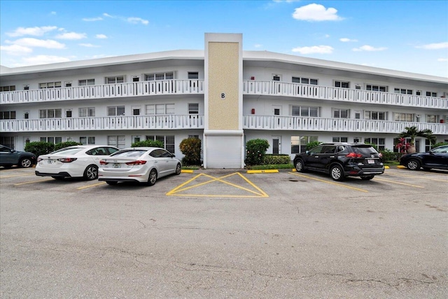 view of property featuring uncovered parking