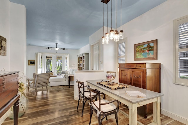 dining room with ceiling fan and wood-type flooring