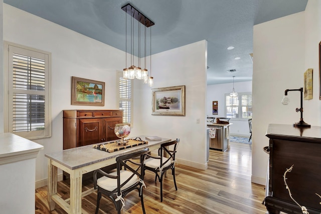 dining space featuring light wood-type flooring