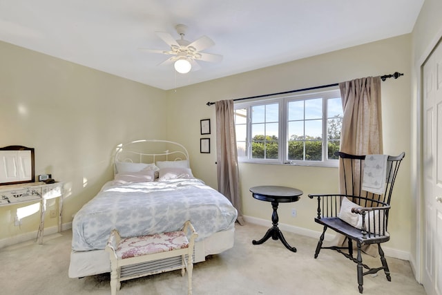 carpeted bedroom featuring ceiling fan and a closet