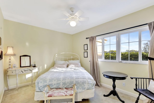 bedroom with ceiling fan and light colored carpet