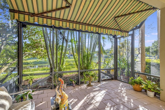 unfurnished sunroom with a water view