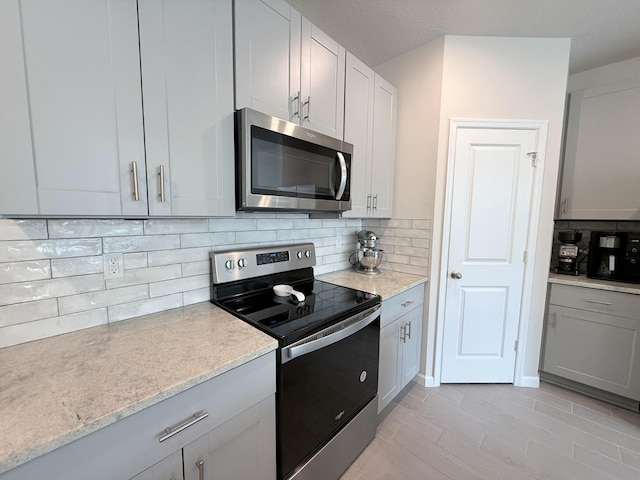 kitchen featuring stainless steel appliances and decorative backsplash