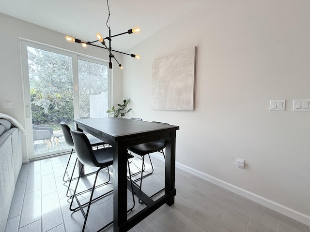 dining area featuring light hardwood / wood-style flooring and a chandelier