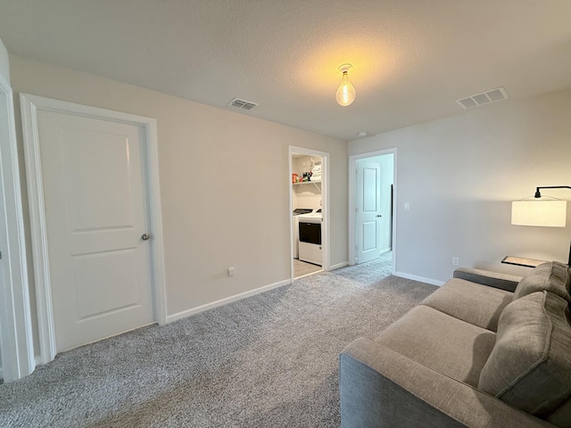 carpeted living room featuring a textured ceiling