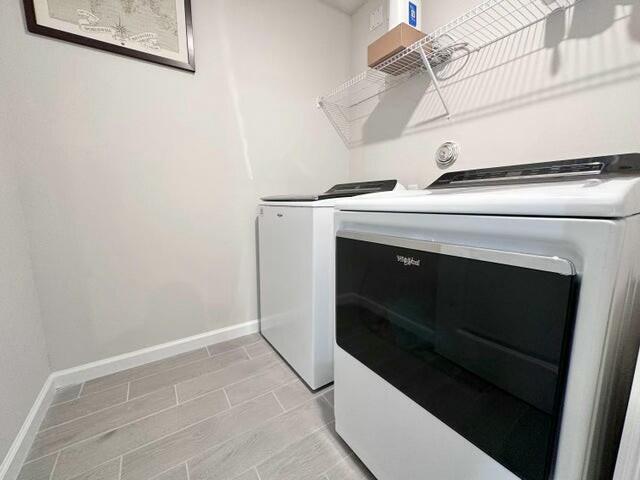 clothes washing area featuring independent washer and dryer