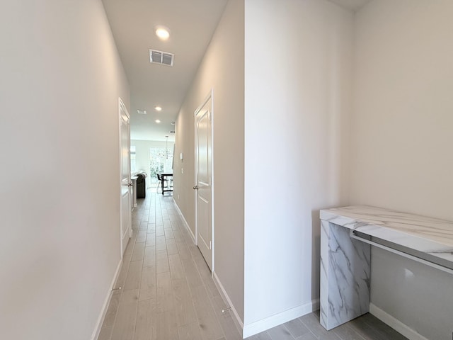 corridor with light wood-type flooring