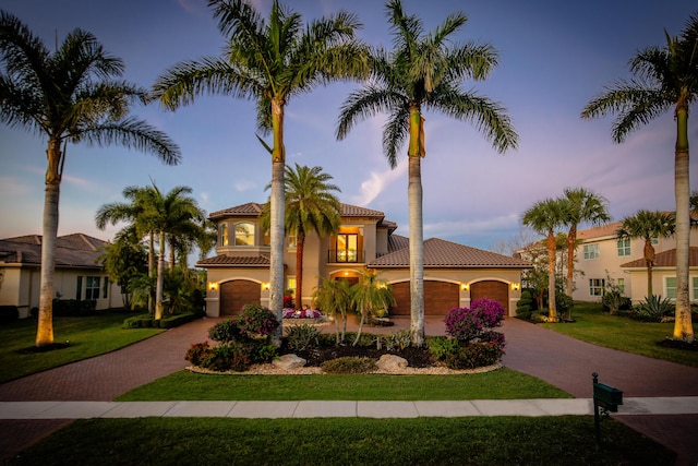 mediterranean / spanish home featuring a lawn