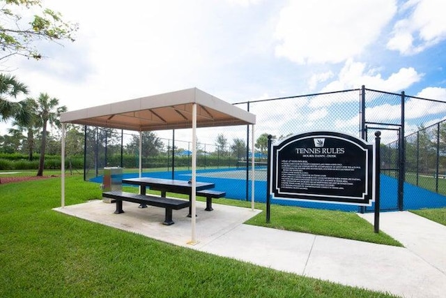 view of home's community featuring a gazebo, a lawn, and tennis court