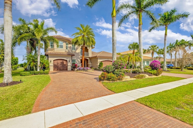 mediterranean / spanish-style home featuring a garage and a front lawn