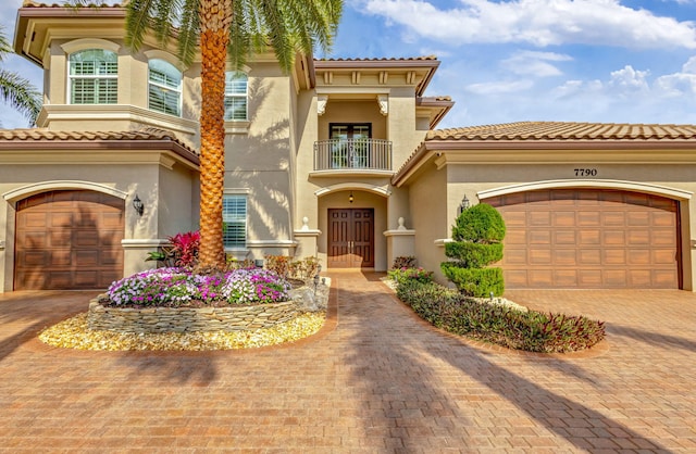 mediterranean / spanish-style home featuring a balcony and a garage