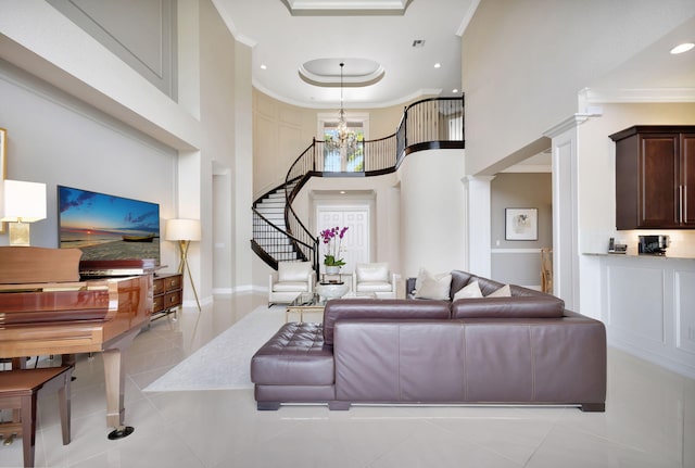 living room featuring light tile patterned floors, crown molding, a chandelier, and a high ceiling