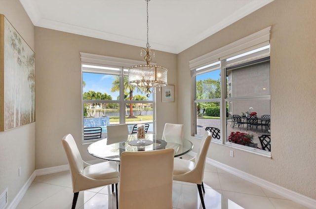 dining area with ornamental molding, a chandelier, light tile patterned floors, and a wealth of natural light