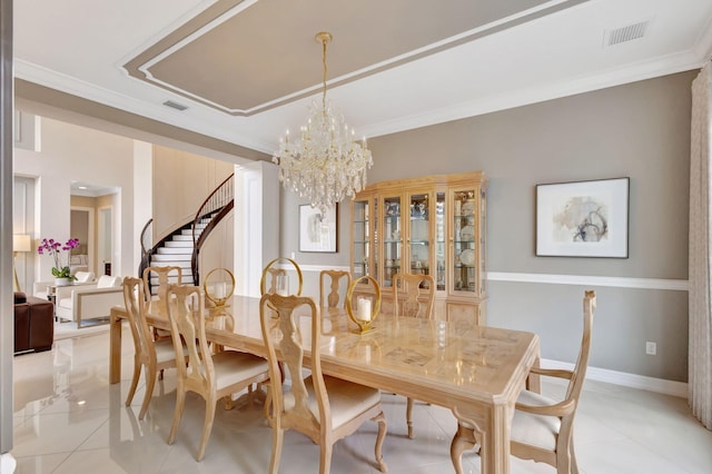 tiled dining area with a notable chandelier and crown molding