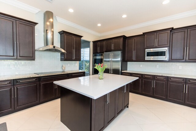 kitchen featuring dark brown cabinetry, sink, hanging light fixtures, light tile patterned floors, and stainless steel dishwasher