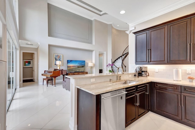 kitchen featuring light stone countertops, light tile patterned flooring, decorative backsplash, stainless steel dishwasher, and kitchen peninsula