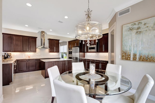 dining area featuring ornamental molding, sink, and a notable chandelier