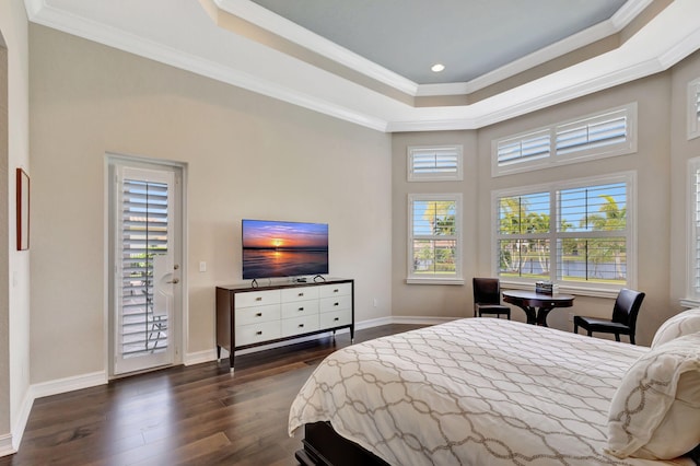 bedroom with crown molding, a tray ceiling, dark wood-type flooring, and access to exterior