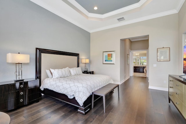 bedroom featuring a raised ceiling, crown molding, and dark hardwood / wood-style flooring