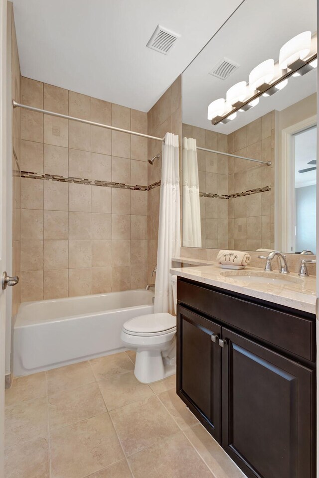 full bathroom featuring vanity, shower / bath combination with curtain, and toilet