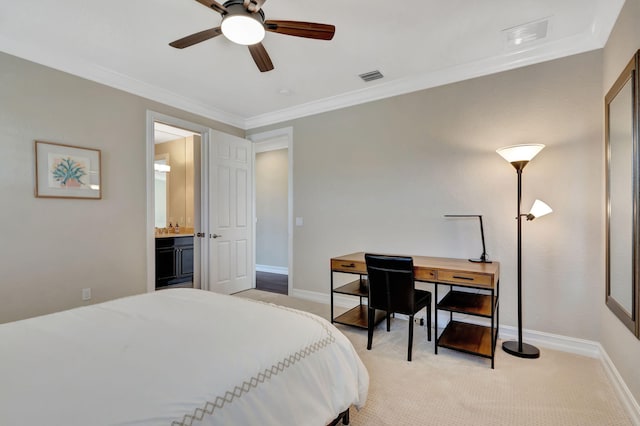 bedroom featuring light carpet, crown molding, and ensuite bathroom