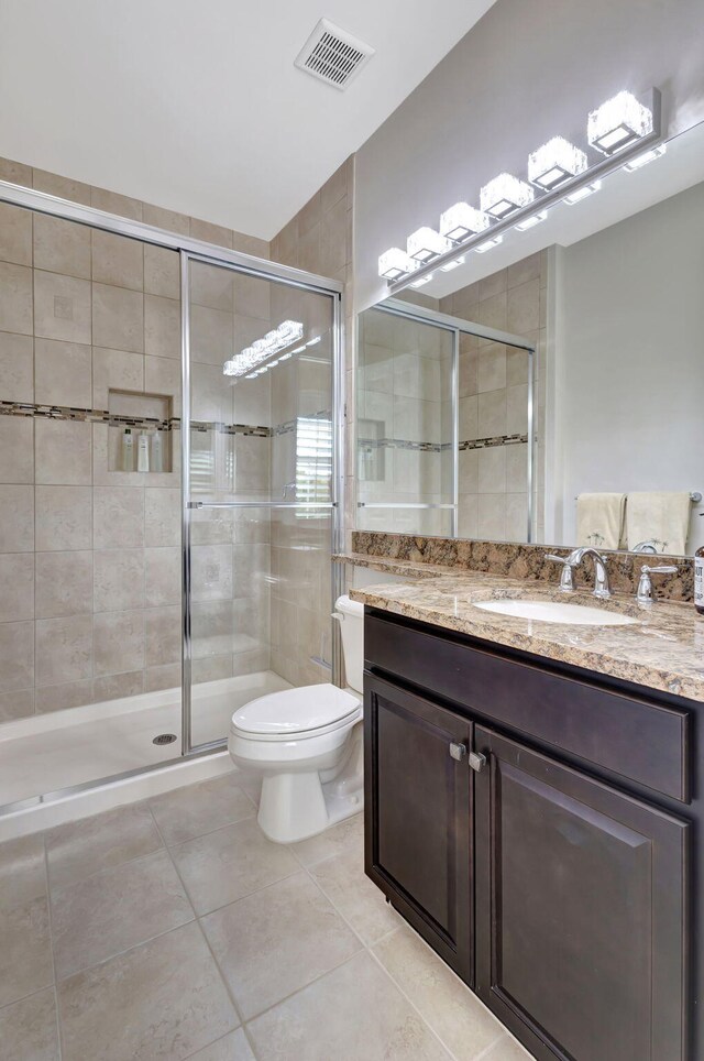 bathroom with vanity, toilet, and an enclosed shower