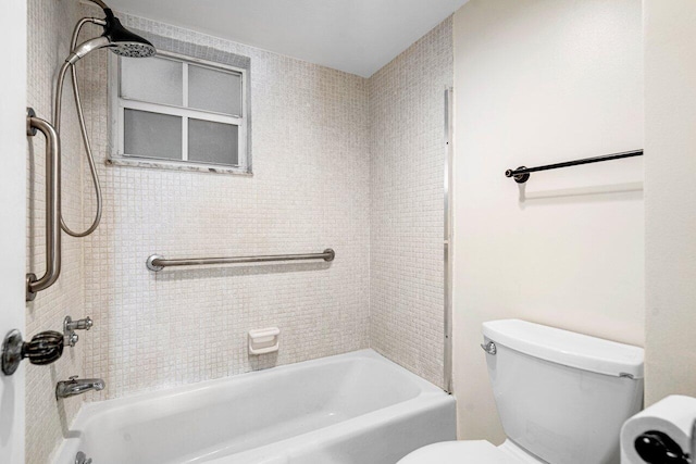 bathroom with toilet and tiled shower / bath combo