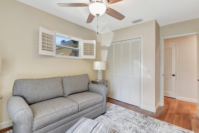 living room featuring ceiling fan and hardwood / wood-style floors