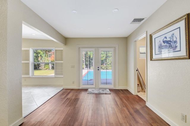 doorway with hardwood / wood-style flooring and french doors