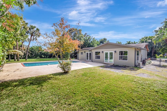 back of house featuring a yard, a patio area, and french doors