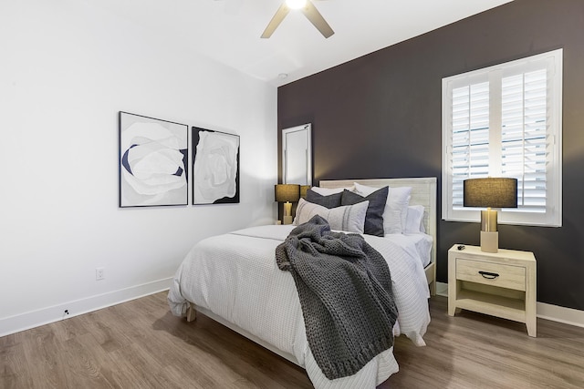 bedroom featuring wood-type flooring and ceiling fan