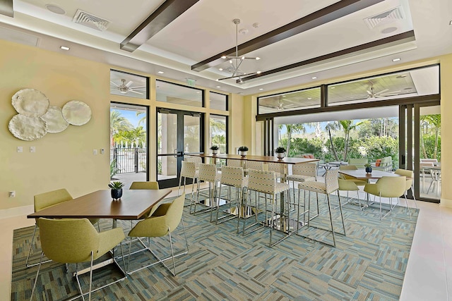 dining room featuring french doors, a towering ceiling, and beamed ceiling