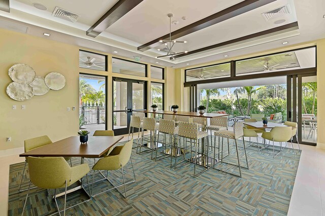 exercise room featuring light carpet and a towering ceiling