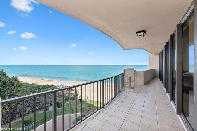 balcony with a view of the beach and a water view