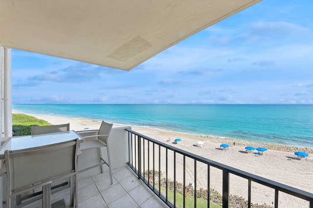 balcony with a view of the beach and a water view