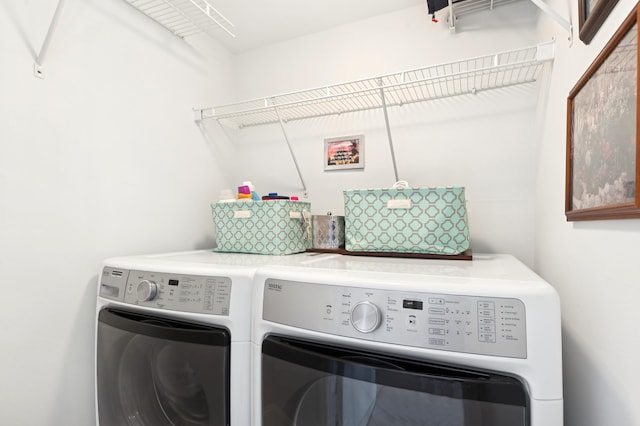 washroom featuring washing machine and dryer