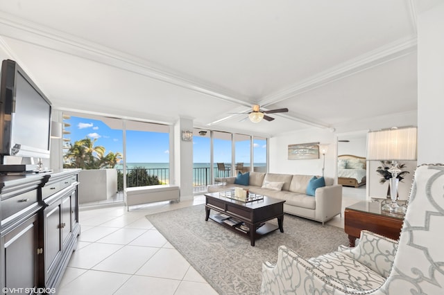 tiled living room featuring ornamental molding, a water view, and ceiling fan