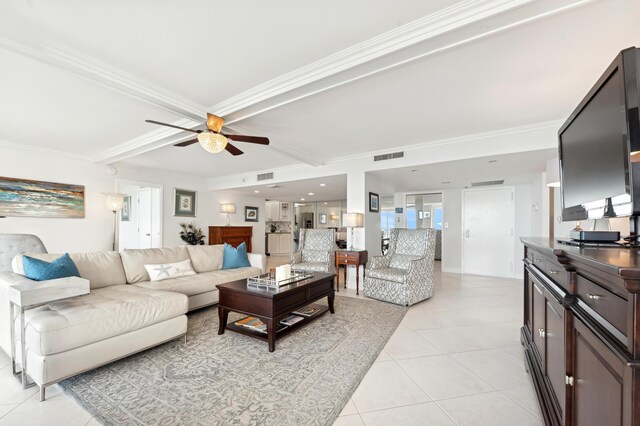 tiled living room with ceiling fan, ornamental molding, and beam ceiling